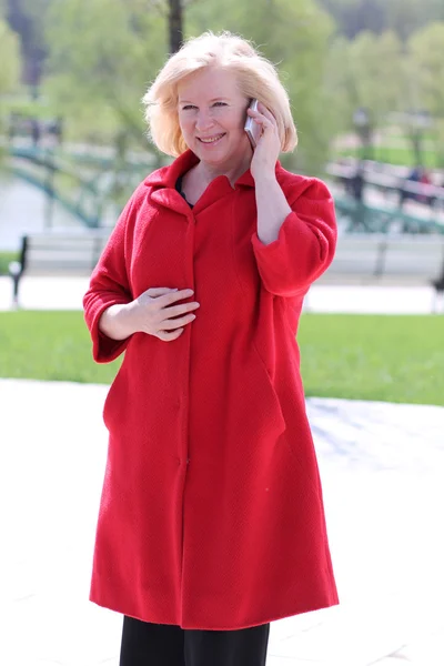 Portrait of senior lady on landline phone call — Stock Photo, Image