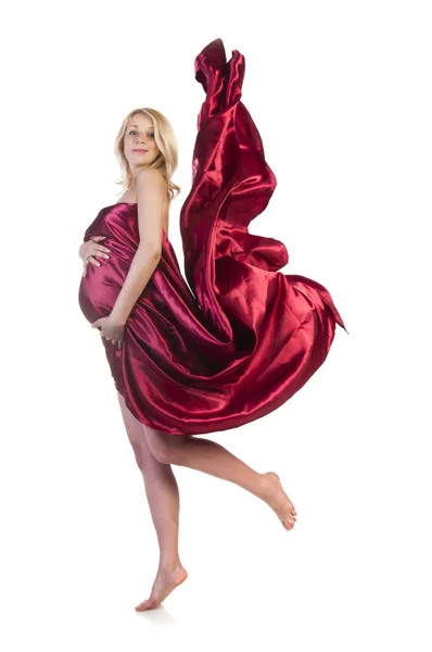 Den gravida tjejen i en lång röd klänning — Stockfoto