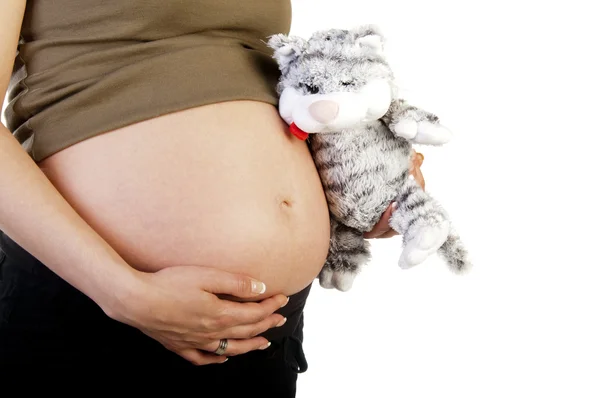 Těhotná matka drží hračky — Stock fotografie