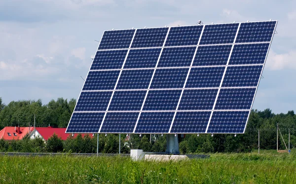 Solar panel station between trees and meadow — Stock Photo, Image