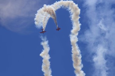 Two planes performing in an air show clipart