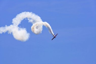 A plane performing in an air show clipart