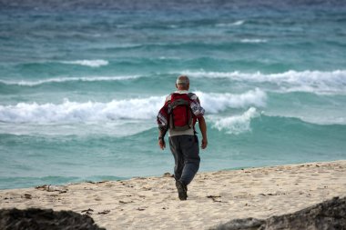 Man walking on the beach in the morning. clipart