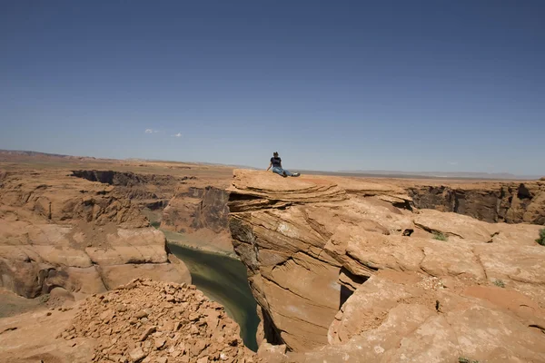 stock image Girl on a top of a rock enjoying the desert panorama