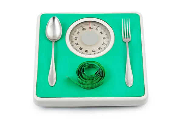 Garfo e colher na balança de peso — Fotografia de Stock