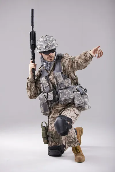Armed Soldier pointing with finger — Stock Photo, Image
