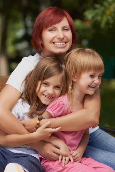 Cute little girls with their mom outdoors — Stock Photo, Image