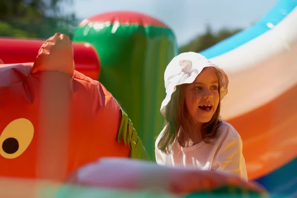 Cute little girl in a jumping castle — Stock Photo, Image