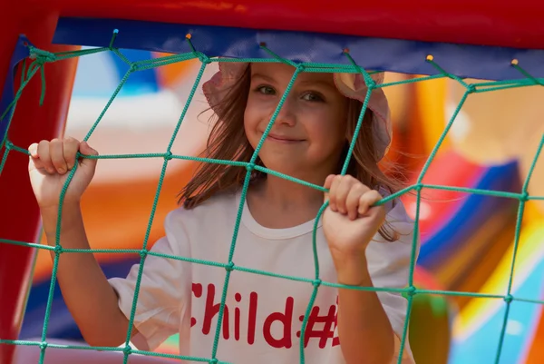 Cute little girl in a jumping castle — Stock Photo, Image