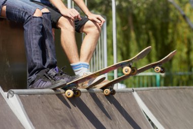 Skates sitting on mini-ramp ready to roll-in clipart