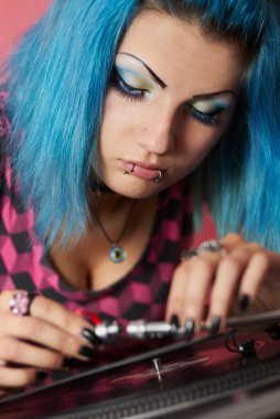 Punk girl DJ with dyed turqouise hair clipart