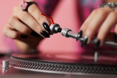 DJ fitting needle to turntable tonearm clipart