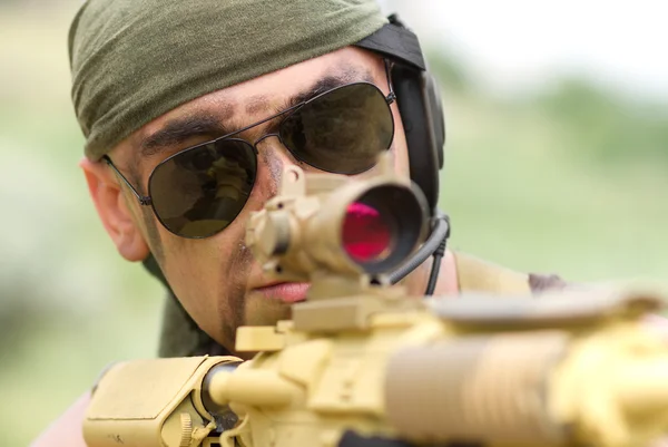 Soldier in sunglasses targeting — Stock Photo, Image