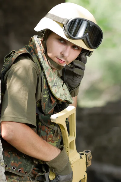 Soldier in helmet talking via headset — Stock Photo, Image