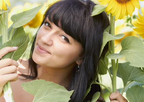 Young girl with sunflowers outdoors — Stock Photo, Image