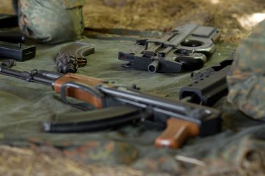 Arsenal of guns lying on the ground clipart