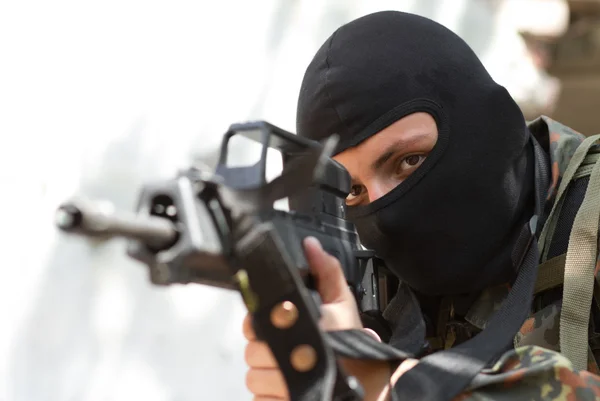 Terrorist i svart mask med en pistol — Stockfoto