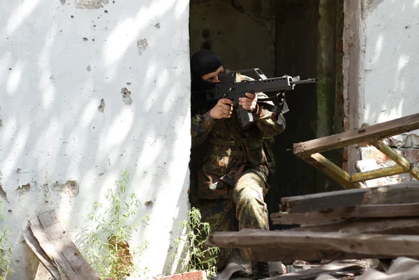 Terrorist in black mask with a gun — Stock Photo, Image
