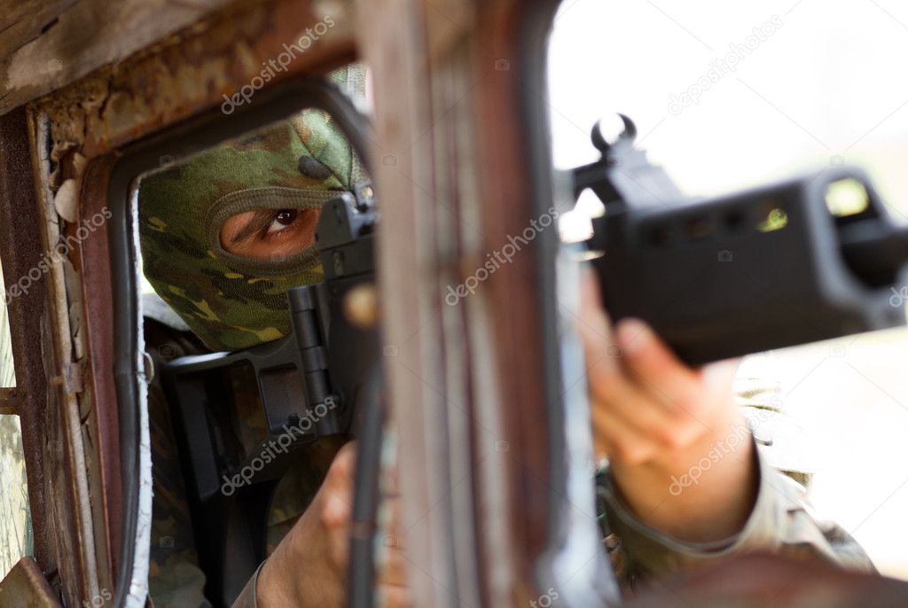 Terrorist in mask with a gun