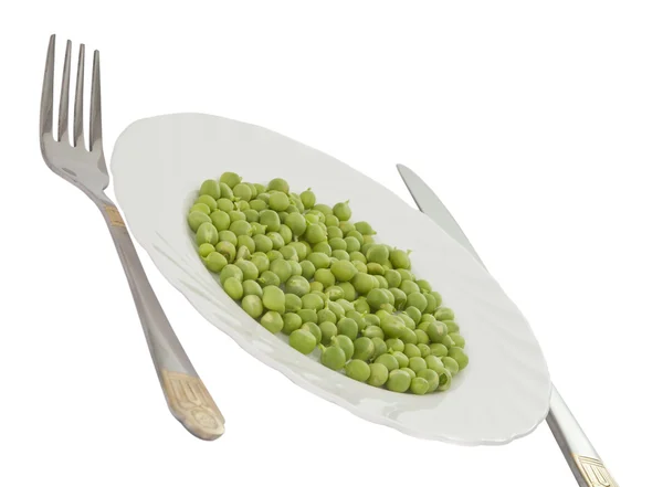 Frische grüne Erbsen auf einem Teller — Stockfoto