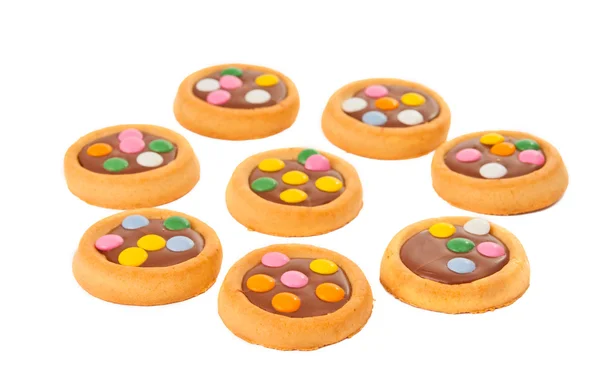Biscotti con cioccolato al latte e fagioli colorati isolat — Foto Stock