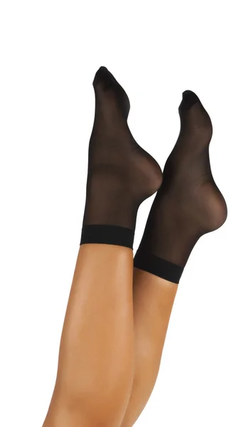 Schwarze Nylonsocken weibliche Füße. — Stockfoto