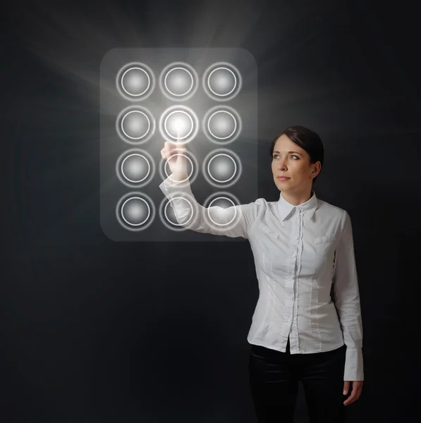 Woman pushing button on dial panel Stock Picture