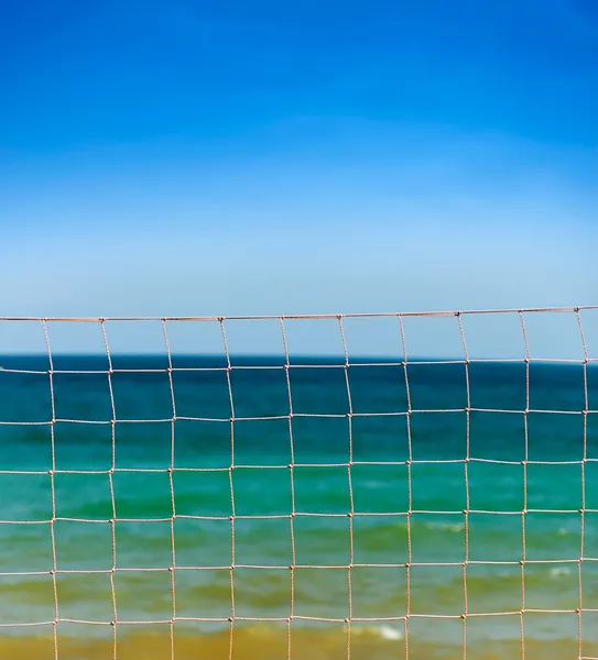 Net over blue sky and sea waves Royalty Free Stock Images