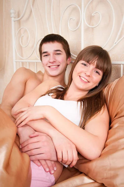 Couple bedroom embracing and smiling — Stock Photo, Image