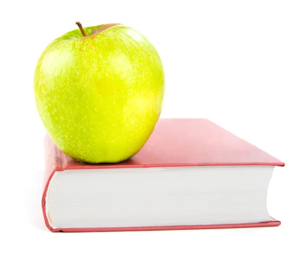 Zelené jablko na knize — Stock fotografie
