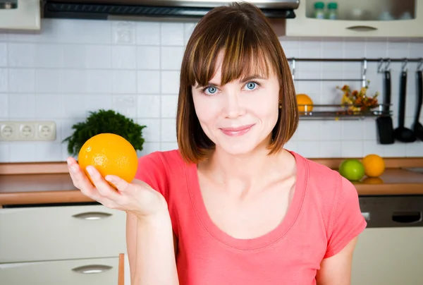 Young happy woman with orange — Stock Photo, Image