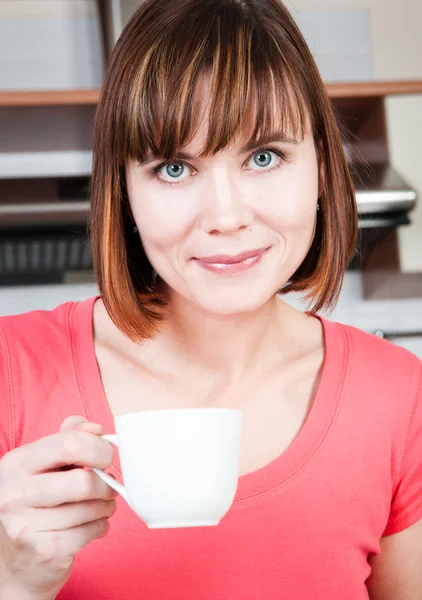 Jonge vrouw genieten van een kopje koffie — Stockfoto