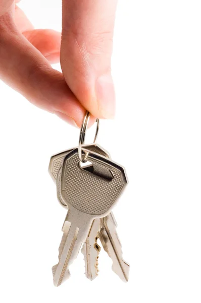 Human hand with keys on white — Stock Photo, Image