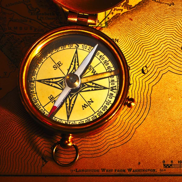 Antique brass compass over old background — Stock Photo, Image
