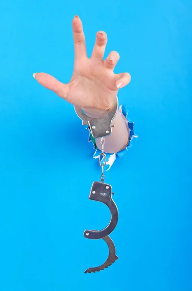 Hand with handcuffs out of paper — Stock Photo, Image