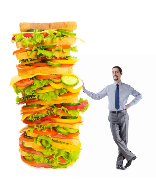 Uomo e panino gigante su bianco — Foto Stock
