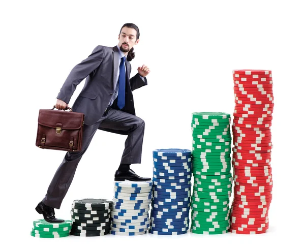 Empresário escalando pilhas de fichas de casino — Fotografia de Stock