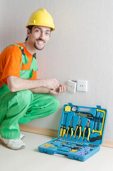 Electrician repairman working in the house Stock Picture