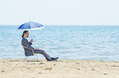 Man with umbrella on seaside beach clipart