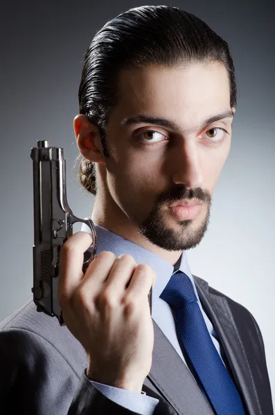 Homem de negócios com pistola de mão — Fotografia de Stock