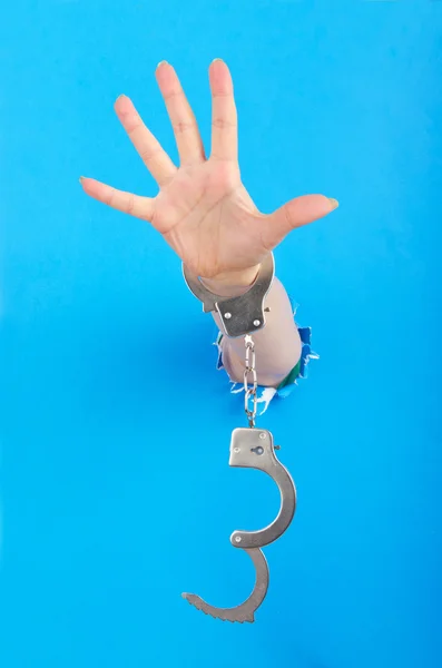 Hand with handcuffs out of paper — Stock Photo, Image