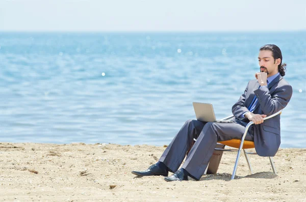 stock image Businessman working on laptop on seaside