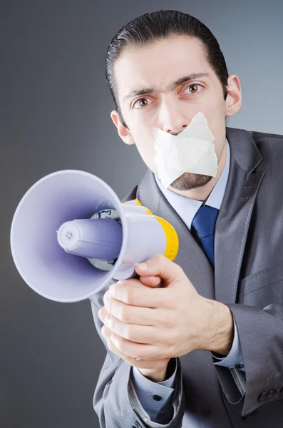 Businessman shouting via loudspeaker — Stock Photo, Image
