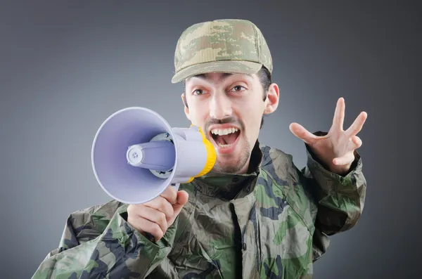 Soldier with loudspeaker shouting — Stock Photo, Image