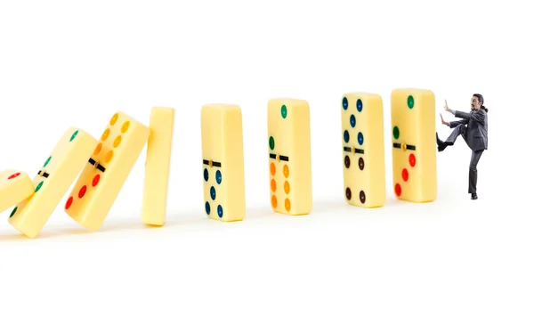 Empresário e dominós isolados no branco — Fotografia de Stock