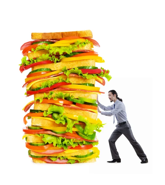 Muž a obří sendvič na bílém pozadí — Stock fotografie