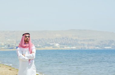 Arab on seaside in traditional clothing