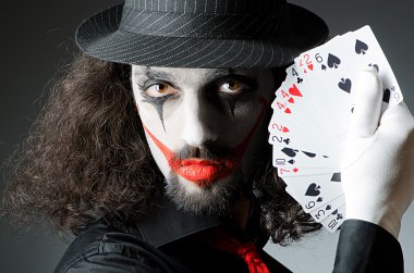 Joker with cards in studio shoot clipart