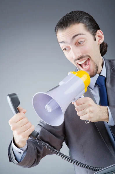 Businessman shouting via loudspeaker — Stock Photo, Image