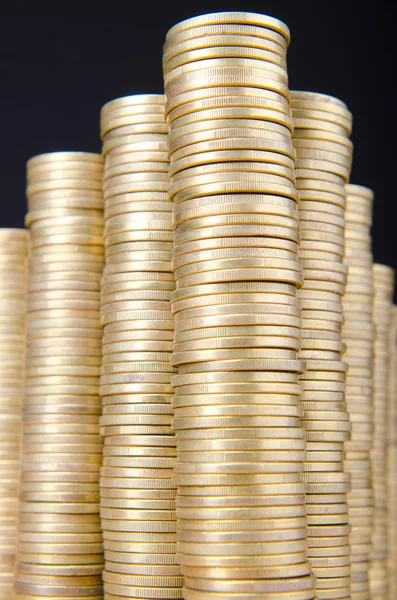 Golden coins in high stacks — Stock Photo, Image